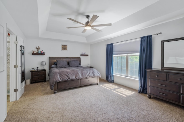 103 Fawn Trl, Neosho, MO 64850 - bedroom with a tray ceiling, light carpet, and ceiling fan