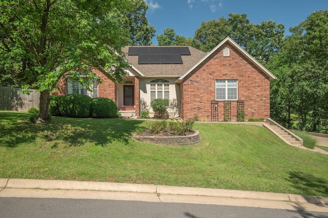 103 Fawn Trl, Neosho, MO 64850 - view of front of home featuring brick siding, solar panels, and a shingled roof
