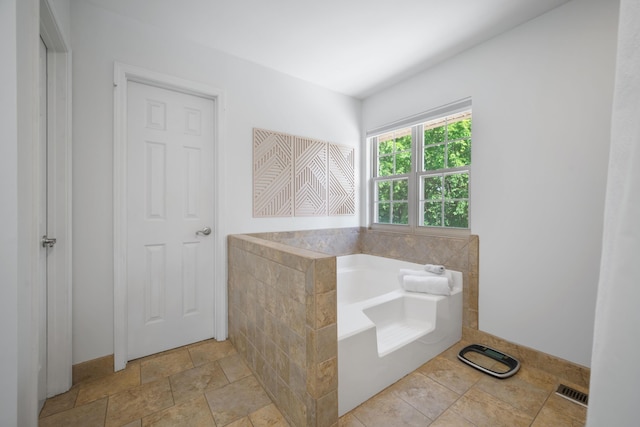 103 Fawn Trl, Neosho, MO 64850 - bathroom featuring a garden tub and stone finish flooring