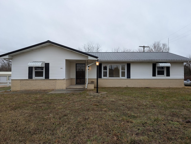 600 N Main St, Pleasant Hope, MO 65725 - view of front of home with brick siding, a front yard, and a metal roof