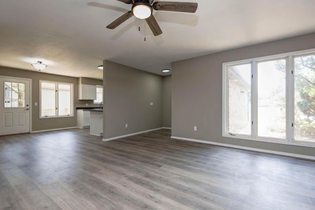 3229 W Hanover St, Springfield, MO 65807 - unfurnished living room featuring wood finished floors and a ceiling fan