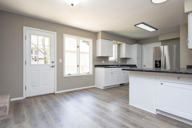 3229 W Hanover St, Springfield, MO 65807 - kitchen with stainless steel fridge with ice dispenser, white cabinetry, and plenty of natural light