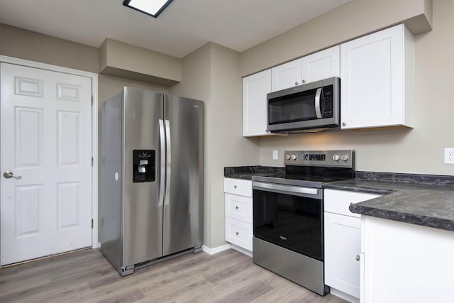 3229 W Hanover St, Springfield, MO 65807 - kitchen featuring stainless steel appliances, light wood-style floors, and white cabinets