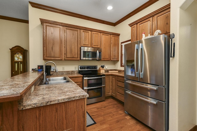 760 S 21st Ave, Ozark, MO 65721 - kitchen with stainless steel appliances, a peninsula, brown cabinets, crown molding, and wood finished floors