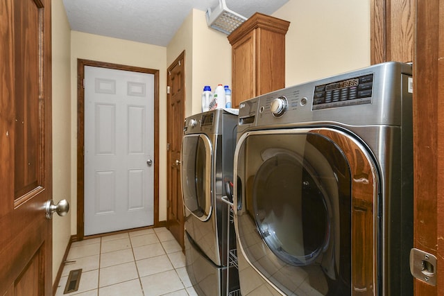 760 S 21st Ave, Ozark, MO 65721 - laundry area with washing machine and clothes dryer, light tile patterned floors, and cabinet space
