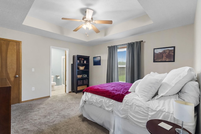 3262 E Colonial St, Republic, MO 65738 - bedroom featuring a tray ceiling, light carpet, ensuite bathroom, and a ceiling fan