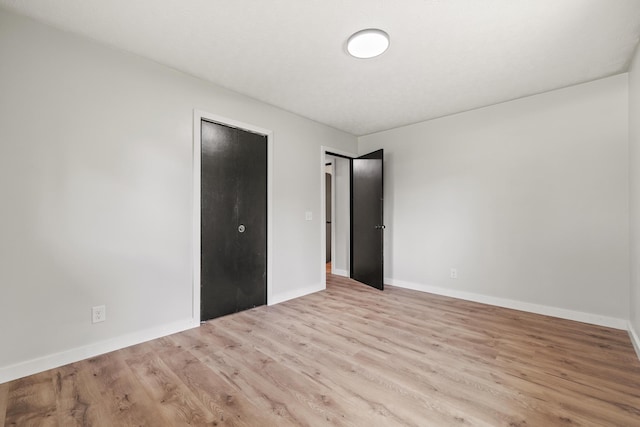 302 W Howard Ave, Billings, MO 65610 - unfurnished bedroom featuring wood finished floors and baseboards