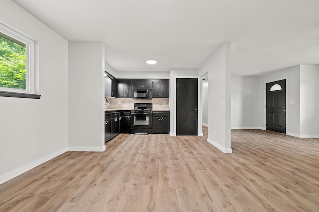 302 W Howard Ave, Billings, MO 65610 - kitchen featuring black appliances, dark cabinets, decorative backsplash, light countertops, and light wood-style flooring