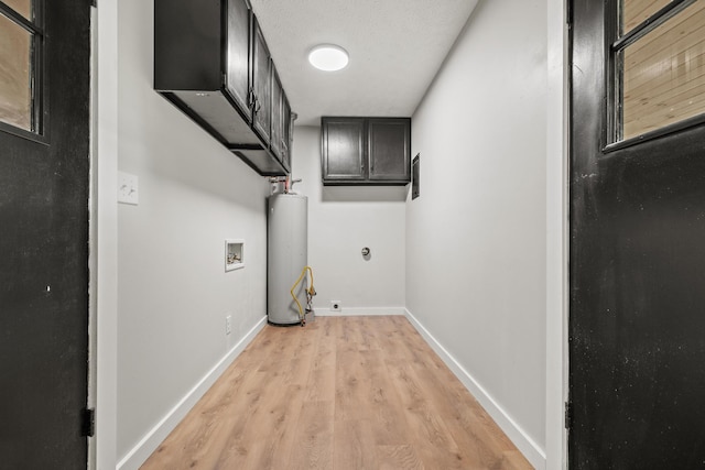 302 W Howard Ave, Billings, MO 65610 - washroom with water heater, light wood-style floors, cabinet space, and washer hookup