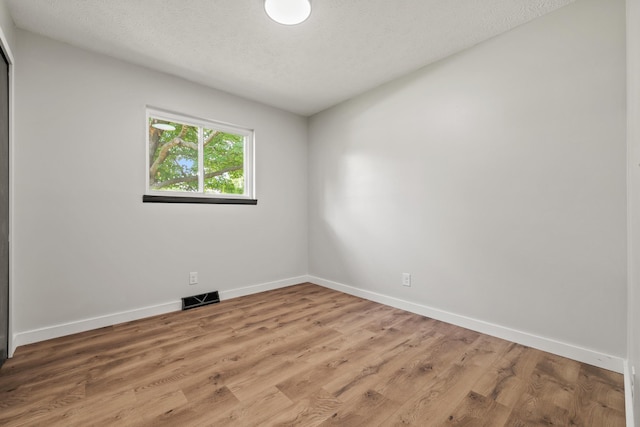 302 W Howard Ave, Billings, MO 65610 - unfurnished room featuring light wood-style floors and a textured ceiling