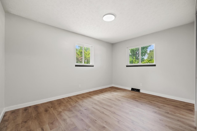 302 W Howard Ave, Billings, MO 65610 - spare room featuring wood finished floors and a textured ceiling