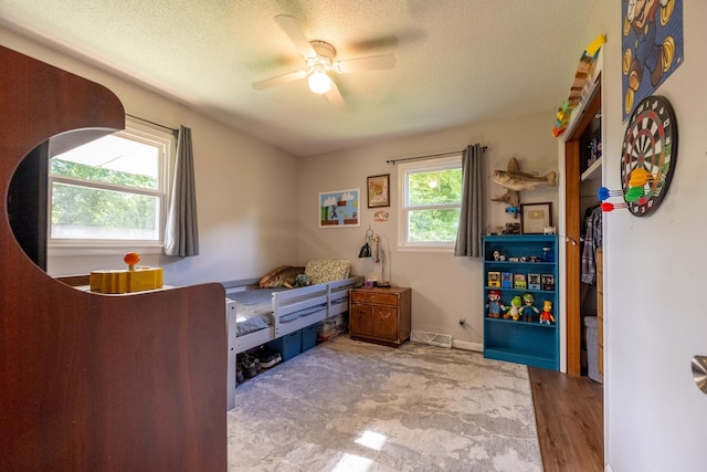1119 S Cedarbrook Ave, Springfield, MO 65804 - bedroom featuring a textured ceiling, ceiling fan, and wood finished floors
