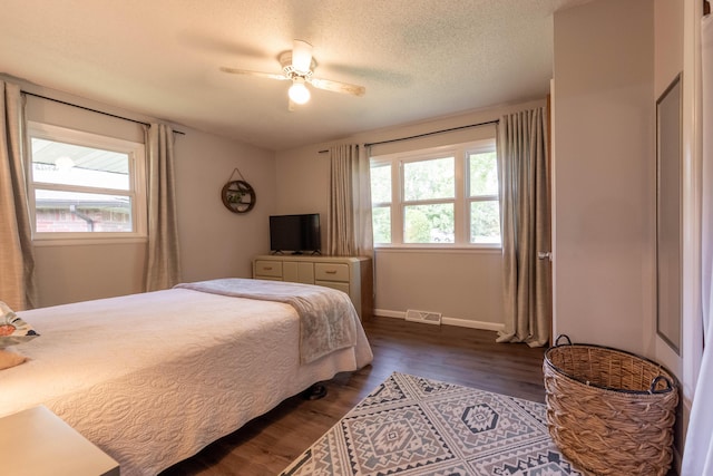1119 S Cedarbrook Ave, Springfield, MO 65804 - bedroom featuring dark wood finished floors, a ceiling fan, and a textured ceiling