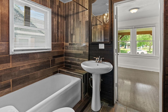 2101 N Main Ave, Springfield, MO 65803 - full bath with wood walls, a bathtub, and wood finished floors