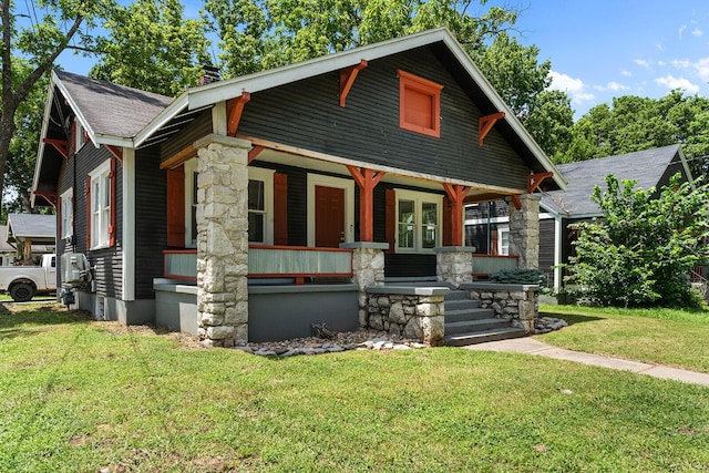 2101 N Main Ave, Springfield, MO 65803 - craftsman inspired home with covered porch, a front yard, a chimney, and a shingled roof