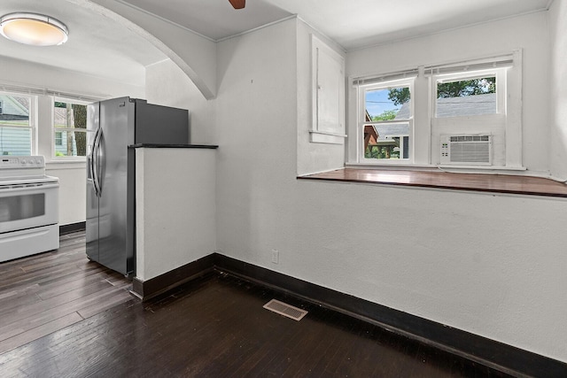 2101 N Main Ave, Springfield, MO 65803 - kitchen with electric range, dark wood finished floors, arched walkways, stainless steel refrigerator with ice dispenser, and cooling unit