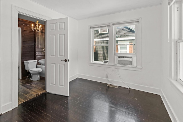 2101 N Main Ave, Springfield, MO 65803 - spare room with a chandelier, dark wood finished floors, and cooling unit