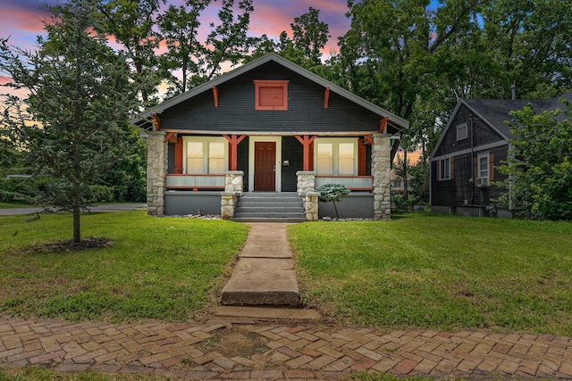 2101 N Main Ave, Springfield, MO 65803 - bungalow-style home featuring covered porch, a front lawn, and stone siding