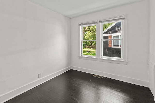 2101 N Main Ave, Springfield, MO 65803 - spare room with dark wood-type flooring and baseboards