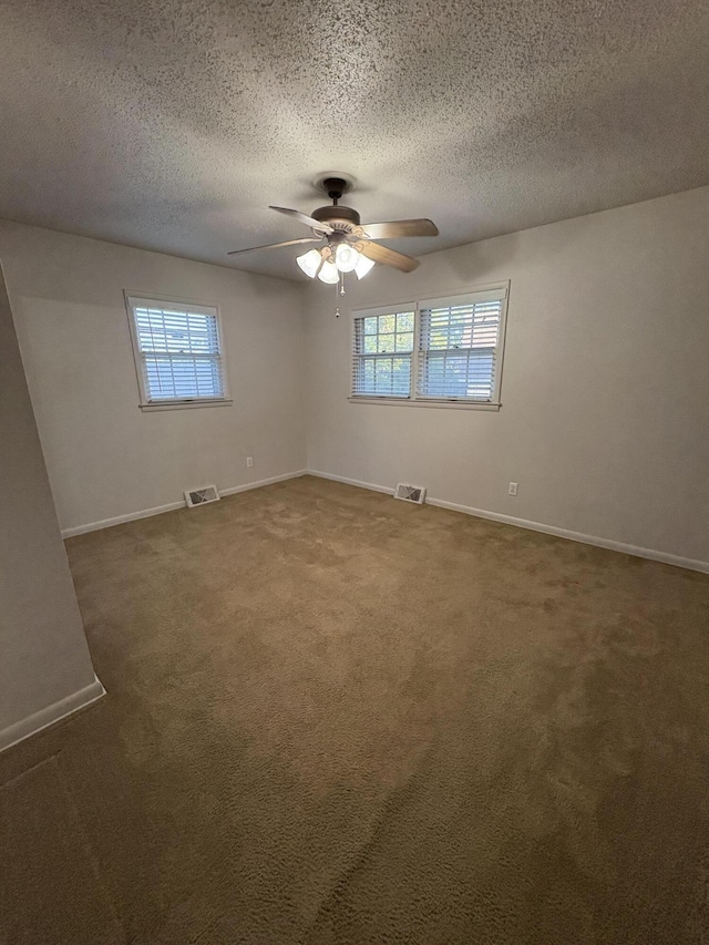 311 Crestwood Dr, Neosho, MO 64850 - carpeted empty room with healthy amount of natural light, ceiling fan, and a textured ceiling