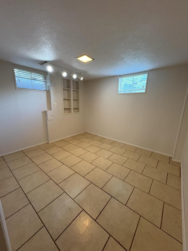 311 Crestwood Dr, Neosho, MO 64850 - basement featuring a textured ceiling and light tile patterned floors