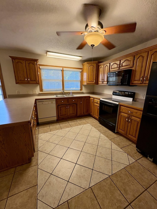 311 Crestwood Dr, Neosho, MO 64850 - kitchen featuring black appliances, light tile patterned floors, a textured ceiling, a ceiling fan, and brown cabinets