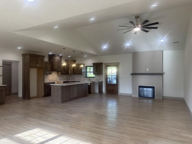 1988 Morris Rd Unit B, Mountain Grove, MO 65711 - kitchen with open floor plan, high vaulted ceiling, a kitchen island, a ceiling fan, and light countertops