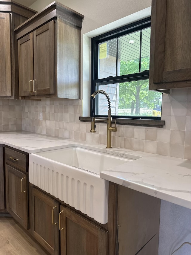 1988 Morris Rd Unit B, Mountain Grove, MO 65711 - kitchen with backsplash, light wood-style flooring, and light stone counters