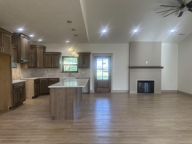 1988 Morris Rd Unit B, Mountain Grove, MO 65711 - kitchen featuring light wood-type flooring, a kitchen island, ceiling fan, tasteful backsplash, and recessed lighting