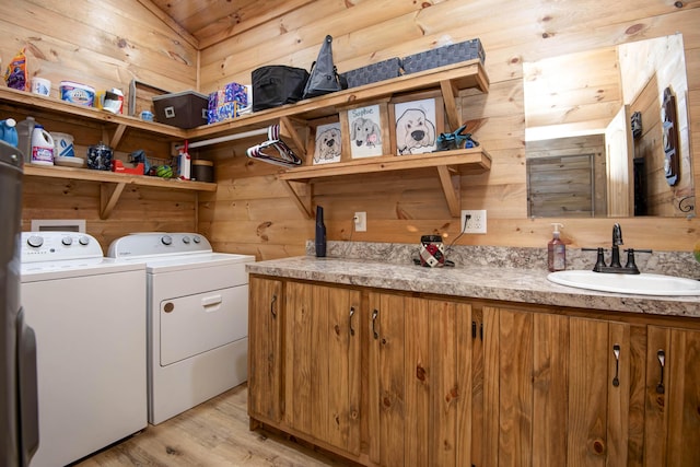 119 Allison Bnd, Lampe, MO 65681 - washroom featuring washer and clothes dryer, wood walls, and light wood-style flooring