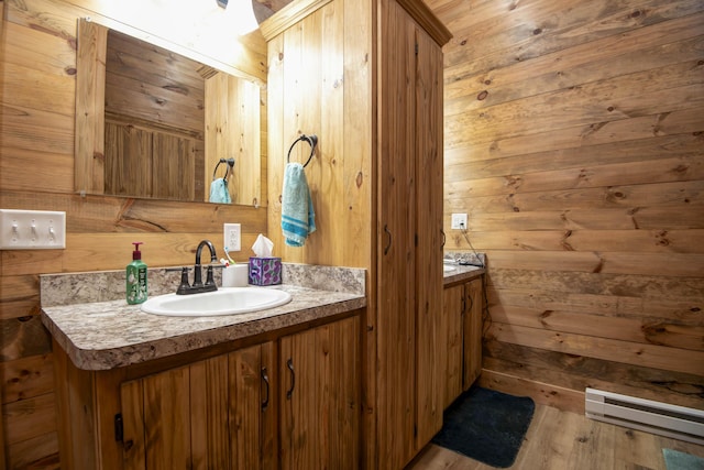 119 Allison Bnd, Lampe, MO 65681 - bathroom with vanity, wooden walls, a baseboard heating unit, and wood finished floors