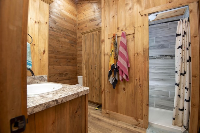 119 Allison Bnd, Lampe, MO 65681 - bathroom featuring a shower with curtain, vanity, wood finished floors, and wooden walls
