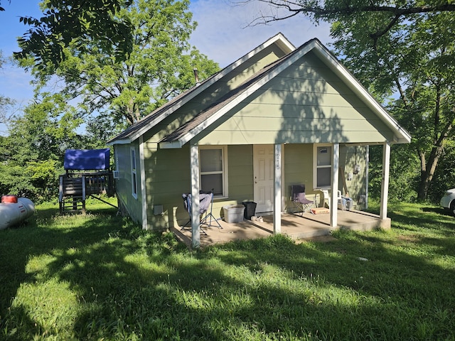 1215 Jefferson Ave, West Plains, MO 65775 - rear view of property with a lawn and a patio