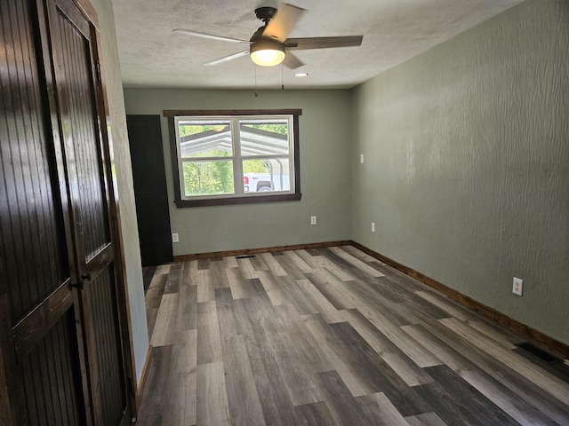 401 Walnut St, Ava, MO 65608 - empty room with wood finished floors, ceiling fan, and a textured ceiling
