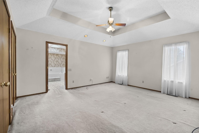 4059 E Linwood St, Springfield, MO 65809 - empty room featuring plenty of natural light, ceiling fan, a raised ceiling, light carpet, and a textured ceiling