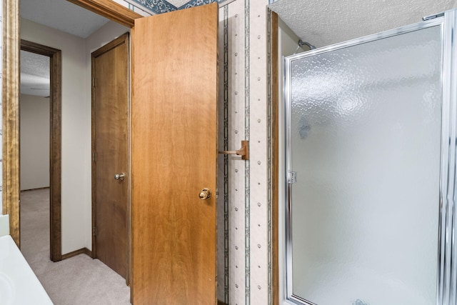 4059 E Linwood St, Springfield, MO 65809 - bathroom featuring a shower stall and a textured ceiling