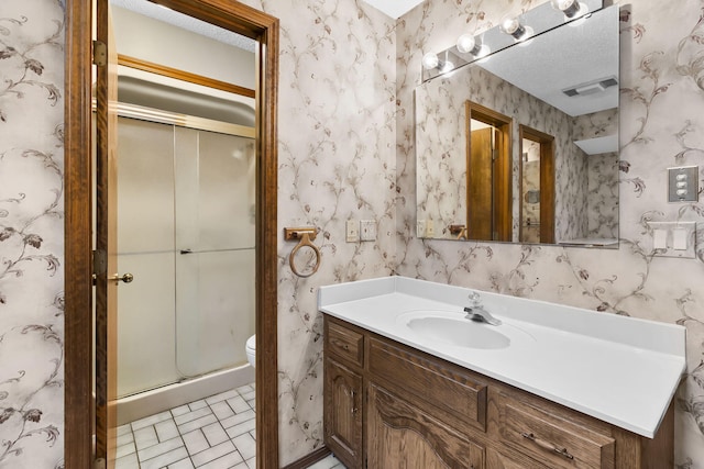 4059 E Linwood St, Springfield, MO 65809 - bathroom featuring vanity, a stall shower, wallpapered walls, and a textured ceiling