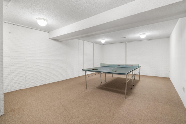 4059 E Linwood St, Springfield, MO 65809 - playroom with carpet floors, brick wall, and a textured ceiling