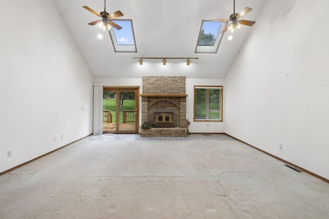 4059 E Linwood St, Springfield, MO 65809 - unfurnished living room with a skylight, high vaulted ceiling, a ceiling fan, carpet floors, and rail lighting