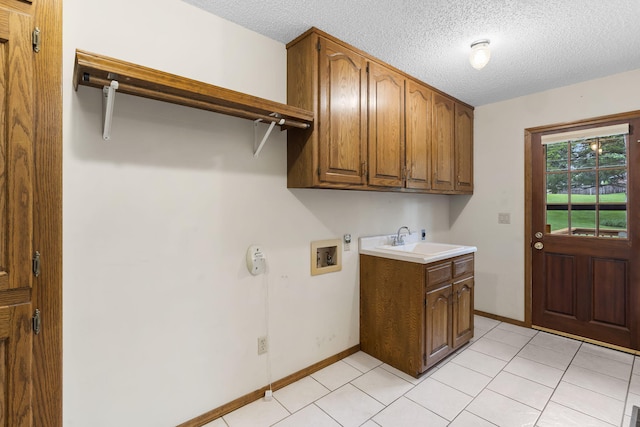 4059 E Linwood St, Springfield, MO 65809 - laundry area featuring cabinet space, hookup for a washing machine, a textured ceiling, and light tile patterned floors