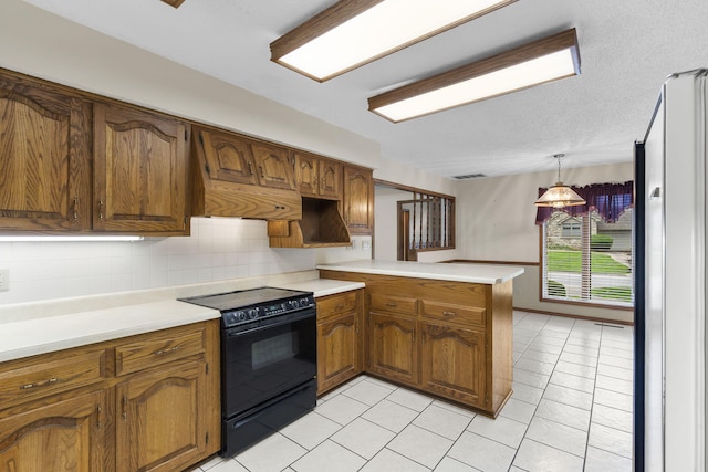 4059 E Linwood St, Springfield, MO 65809 - kitchen with black range with electric stovetop, freestanding refrigerator, a peninsula, brown cabinets, and light tile patterned flooring
