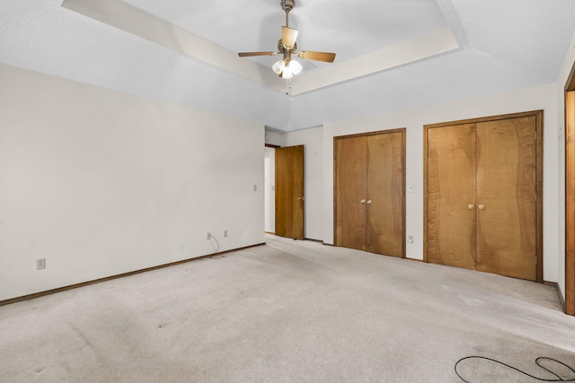 4059 E Linwood St, Springfield, MO 65809 - unfurnished bedroom featuring a raised ceiling, carpet, two closets, and a ceiling fan