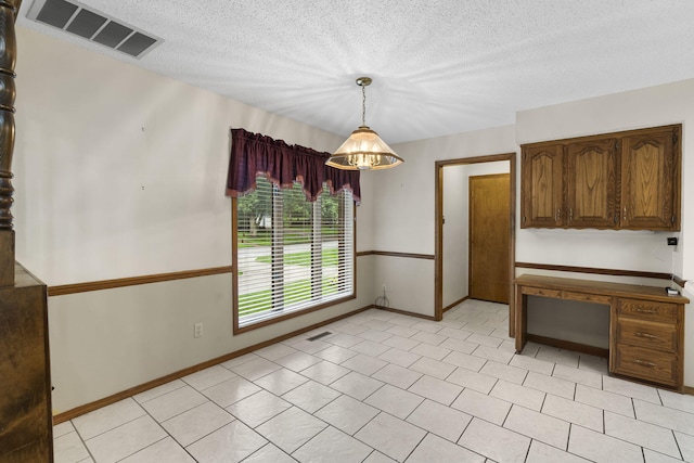 4059 E Linwood St, Springfield, MO 65809 - unfurnished dining area featuring baseboards and a textured ceiling