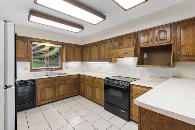 4059 E Linwood St, Springfield, MO 65809 - kitchen featuring black appliances, decorative backsplash, light countertops, brown cabinets, and light tile patterned floors