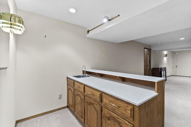 4059 E Linwood St, Springfield, MO 65809 - kitchen featuring light carpet, a peninsula, light countertops, brown cabinetry, and recessed lighting