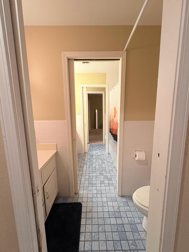 2412 S Camber Ave, Springfield, MO 65809 - full bathroom with tile walls, vanity, wainscoting, tile patterned floors, and a shower with curtain