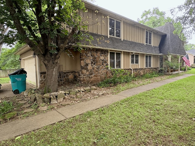 2412 S Camber Ave, Springfield, MO 65809 - view of front of property featuring board and batten siding, stone siding, a front yard, and roof with shingles