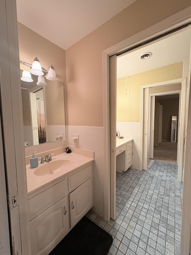 2412 S Camber Ave, Springfield, MO 65809 - full bath featuring vanity, tile patterned flooring, wainscoting, and tile walls