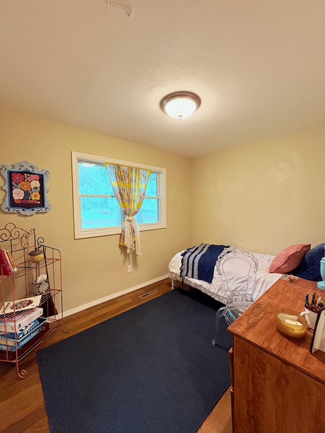 2412 S Camber Ave, Springfield, MO 65809 - bedroom with wood finished floors and a textured ceiling