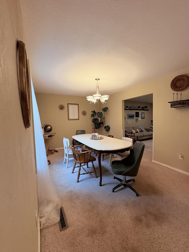 2412 S Camber Ave, Springfield, MO 65809 - carpeted dining space featuring a chandelier and a textured ceiling